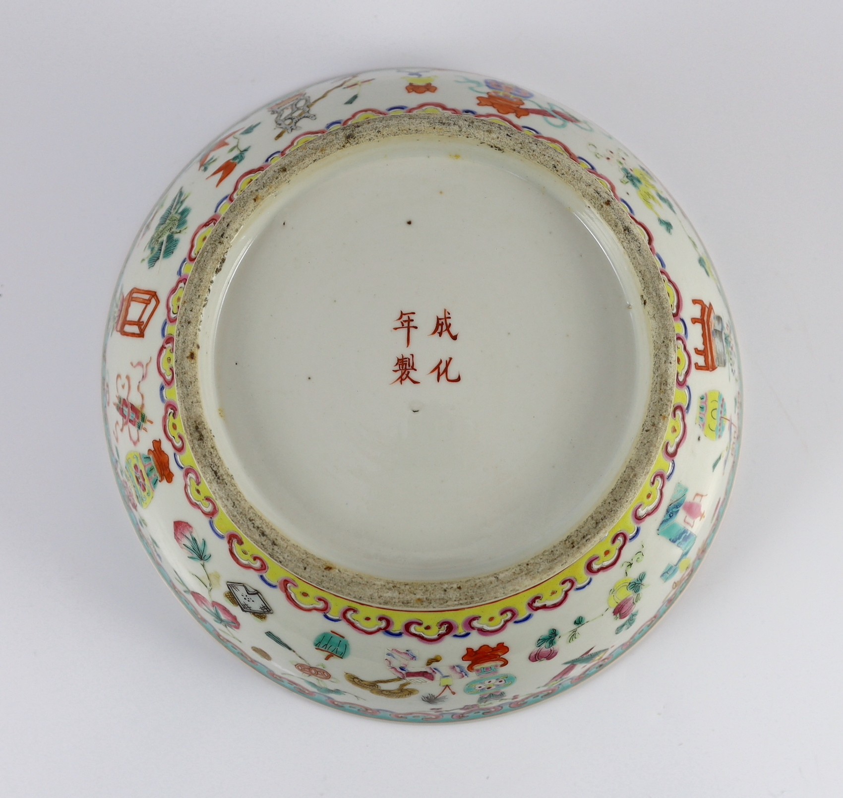 A Chinese famille rose ‘antiques and auspicious objects’ bowl, Chenghua mark, late 19th century, 26.7cm wide, mis-shapen